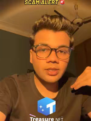 The cover image is a selfie-style shot of a young man with glasses, in front of a warm-toned background. He's looking directly at the camera and talking. Above his head, there's a text overlay that reads 'SCAM ALERT' with an emoji. The logo of 'Treasure.NET' appears at the bottom, indicating the subject of the video. The composition is simple and direct, with the man taking up most of the frame, giving it a personal and conversational vibe.