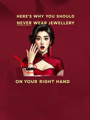 The cover image is a digital illustration with a red background. In the center, there's a stylized female figure in a red dress, her expression is one of surprise. A red arrow points to a black beaded bracelet on her right wrist. Above her is white text, including the title "HERE'S WHY YOU SHOULD NEVER WEAR JEWELLERY". Below the woman, "ON YOUR RIGHT HAND" is displayed in gold text.