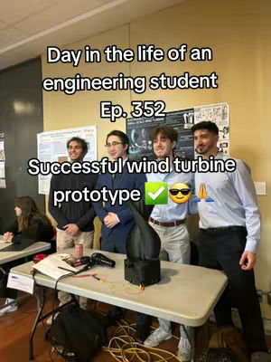 The cover image shows four young men posing indoors. The two men on the right side are wearing light blue button down shirts next to two men wearing casual apparel. On a table in front of them, a miniature wind turbine in a black color has been placed for display.