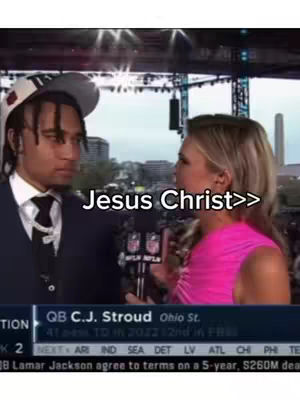 A cover image showing two people, a man and a woman, in front of a background, likely related to sports, with the text overlay 'Jesus Christ>>'. The man is wearing a cap, suit, and tie, and is in a serious pose while being interviewed by the woman on the right, who is wearing a pink dress holding a microphone.