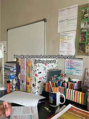 A messy desk with a cluttered workspace filled with books, binders, pens, and papers. A whiteboard and notes are mounted on the wall. Text overlayed indicates a moment, and also a part of a Taylor Swift song. The lighting is natural, creating a sense of a normal study environment.
