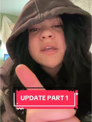 A close-up shot of a person wearing a brown hoodie. The person has dark hair and a nose piercing. A text overlay at the bottom reads 'UPDATE PART 1' in a red box.