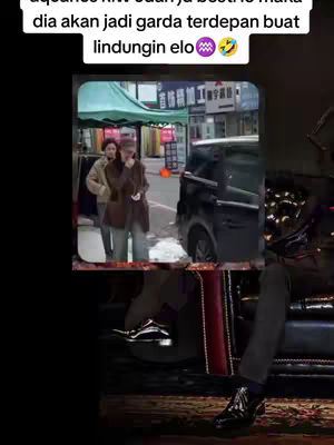 The cover image shows an urban scene with an image in the center, which appears to be a video clip. Above the central image, there's a text overlay containing Indonesian language and emojis. In the foreground, a person is sitting on a chair. The overall composition blends the video frame into a dynamic urban backdrop.