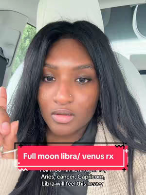 A woman with long, dark hair is seated in a car, looking up at the camera with an expression of thoughtful concern. The image is filled with the softly lit interior of the vehicle. A text box in the bottom center contains information on a celestial event.