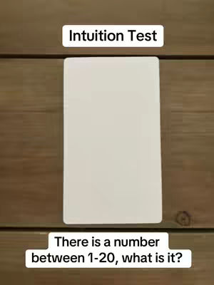 The cover image displays a wooden surface with a playing card in the center. Above the card, a text box reads 'Intuition Test'. Below the card, another text box says, 'There is a number between 1-20, what is it?'