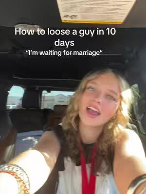 A selfie-style shot taken from inside a vehicle. A young woman with long, wavy blonde hair is centered in the frame, looking towards the camera with a slightly open mouth. She's wearing a white top and a red necklace. The background includes the interior of a vehicle, with parts of the dashboard, windshield, and an overhead panel visible. Text overlays reading, "How to loose a guy in 10 days" and "I'm waiting for marriage" are at the top of the frame.
