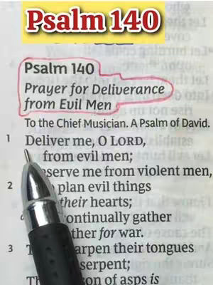The image shows a close-up of an open book page with text from Psalm 140 highlighted and annotated with a red circle and pen. A pen is in the foreground. The background is a textured, off-white page of a book.