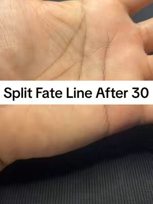 The image shows a close-up of a palm contrasted with a solid, textured surface. The palm, rendered in warm skin tones, displays clear lines and creases. A text overlay in a white rectangular box reads, "Split Fate Line After 30." The overall composition has a simple, informational design with the focus on the palmistry subject.