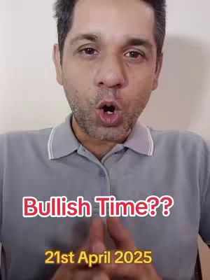 A man with short, dark hair and a gray polo shirt is centered in the frame, with his mouth open as if speaking. Above him, in a box-like text overlay, the words 'Bullish Time??' are displayed in bold red text with a white outline. Below, is a yellow box which reads '21st April 2025'. The background consists of a plain, off-white wall.