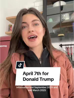 A woman with long brown hair stands in a home kitchen with a red refrigerator, wearing a black top and pink jacket, with a white overlay containing text.