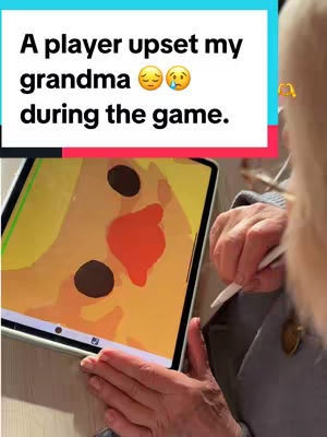 A person's hands are holding a tablet, upon which a drawing of a face is displayed. The video is filmed from over the shoulder of the creator. The background is blurred. A caption is displayed on the image.