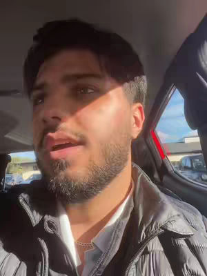 The cover image shows a man sitting in a car, with natural light illuminating his face from one side. He appears to be speaking, possibly filming a video while in transit. The background suggests an outdoor setting with another vehicle visible through the window.