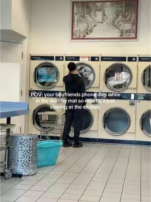 The cover image shows a laundromat with a man standing in front of a washing machine. Text overlayed on the image states "POV: your boyfriends phone dies while in the laundry mat so now he's just staring at the clothes."
