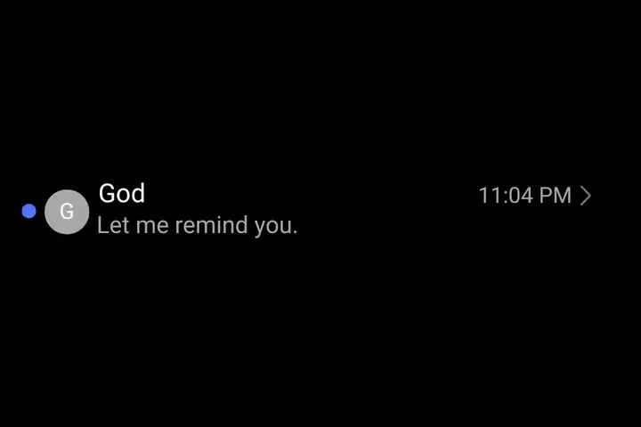 A screenshot of a phone displaying a black screen mimicking a text message. In the chat, the contact is labeled "God" with the text "Let me remind you." The time 11:04 PM is displayed on the right.