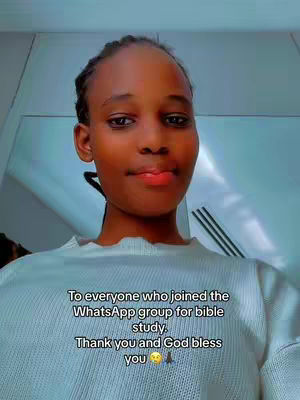 A close-up shot features a young woman with dark skin, looking directly at the camera. She has dark hair pulled back, and a light-colored sweater. Text overlay at the bottom of the image.