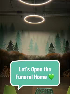 The cover image showcases a light teal speech bubble with white text on the bottom portion of the image. A green heart emoji appears on the right side of the speech bubble. The background features a blurred image of a forest scene with tall pine trees covered in mist. Two ring lights are hanging from the ceiling above the speech bubble.