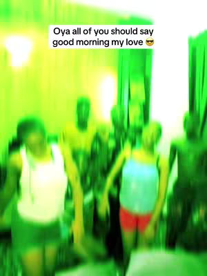 A group of people, mostly people smiling or looking at the camera, are in a room with a green tint. The text from the top is in a box.