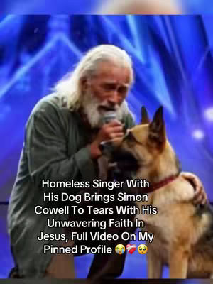 A candid, vertical-oriented image captures a man and his dog sharing a heartwarming moment. The man, with long white hair and a beard, is holding a microphone, likely singing or speaking. He is dressed in a simple green garment and appears emotional. The dog is a German Shepherd, positioned close to the man providing comfort. The background is a blurred, blue stage setting, possibly from a talent show.