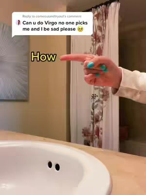 A hand with turquoise painted nails points to the right, with the index finger extended. The word "How" is in a yellow oval. In the background is a bathroom sink and a partially visible mirror with shower curtains.