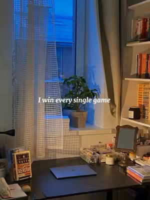 The image shows a room with a desk near a window. A laptop sits on the desk, and there's a potted plant on the windowsill. Sunlight streams through the window, illuminating the scene. Text overlayed in white on top of the image.