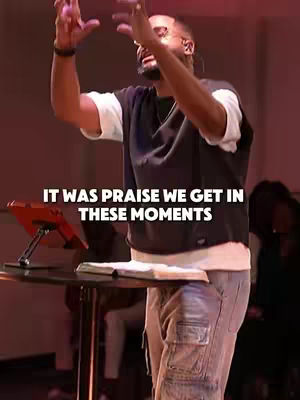 A man with his hands raised in praise in a church setting. Text overlayed on the bottom.