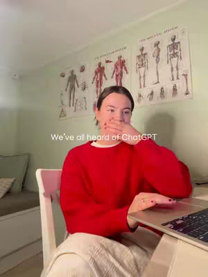 A young woman in a red sweater sits at a desk with a laptop, covering her mouth with her hand. Anatomical charts are visible on the wall behind her. White text overlayed on the image reads "We've all heard of ChatGPT."