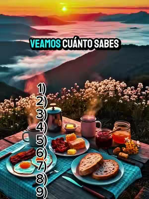 A scenic landscape with a table set for breakfast in the foreground. The background features a mountain range and a vibrant sunset. The table is set with a blue and green checkered tablecloth, various plates of food, and drinks. The central text overlay reads 'VEAMOS CUANTO SABES'.  There are numbers counting down the left side of the Image.