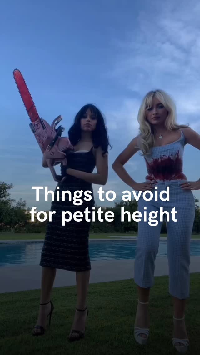 Two women are standing outdoors near a swimming pool under a blue sky. The woman on the left is dressed in a black outfit and holding a pink chainsaw. The woman on the right is wearing a blue and white patterned outfit. The text overlay reads, "Things to avoid for petite height."