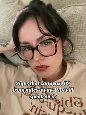 A selfie-style image features a woman with dark hair pulled back, wearing glasses and a lip piercing. The image is taken from a slightly high angle, with the woman lying down, her arm supporting her head. The background is a soft, blurred pattern which may be a couch. Overlayed text highlights the topic.
