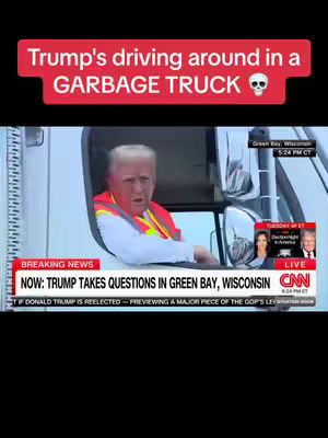 The image shows Donald Trump appearing to be driving a garbage truck. He is in the driver's seat, looking forward. The top of the image has a red banner with white text that states "Trump's driving around in a GARBAGE TRUCK" with a skull emoji.