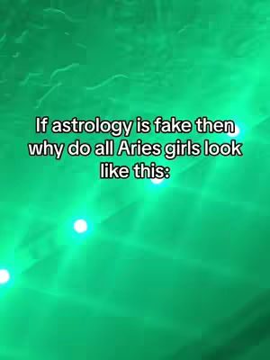 The cover image features a green, textured background with some bright, round highlights. Centered on the image is white text that poses a question about the appearance of Aries girls.
