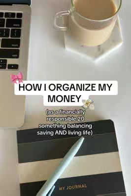 The image shows a top-down view of a table with a laptop, a notebook, a glass of coffee, and a pen. A text overlay reads 'HOW I ORGANIZE MY MONEY' and further explains the content as relating to a financially responsible 20-something. Soft colors and natural lighting create a clean and organized aesthetic
