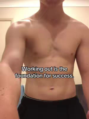 The cover image features a shirtless man in the foreground, showcasing his muscular physique. The background is a plain, neutral wall. Overlayed text at the bottom reads 'Working out is the foundation for success.'