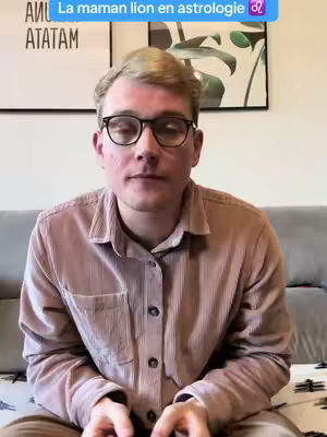 A man with glasses and light-colored hair sits in front of a plain background. He wears a button-down shirt. Text overlay at the top.