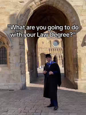 The cover image shows a man in graduation attire standing in front of a stone archway. He is the focal point, and the background suggests a historic building on a sunny day.