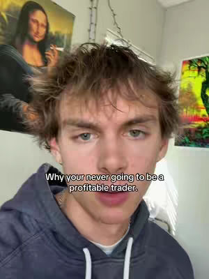 A young man with light skin and brown, unkempt hair is centered in the frame. He wears a dark hoodie and has a serious expression. Above him, a partial image of the Mona Lisa as well as a colorful painting is visible. White text overlay reads, "Why your never going to be a profitable trader."