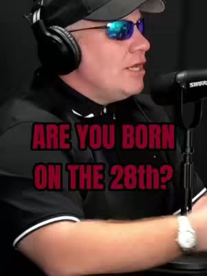 A man wearing sunglasses, a baseball cap, and a headset is speaking while a microphone rests near his mouth, directly in front with some overlayed text.