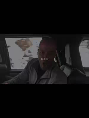 The main character is inside a car looking surprised, looking to the left. There is an explosion in the background.