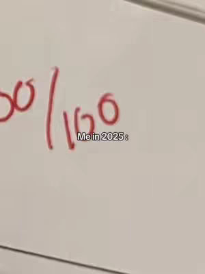A close-up view of a whiteboard with handwritten red text. In the upper left, a fraction is visible, and below that, the text 'Me in 2025:'