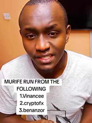 A man with a shaved head is shown, positioned from the chest up, in a selfie-style shot. He wears a light gray t-shirt. A white, rectangular text overlay is placed below his chin, with the words 'MURIFE RUN FROM THE' followed by a numbered list including the names, 'Vainancee', 'cryptofx' and 'benanzor'. The background includes a wall in a light neutral color.