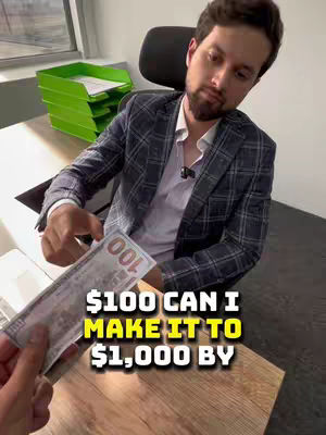 A man in a plaid blazer holds a $100 bill in front of a background where a desk and a stack of green paper trays can be seen. Text overlayed in yellow and white asks if it's possible to make the $100 bill turn into $1,000.