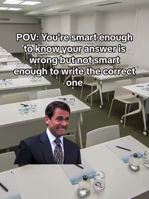 The image presents a meme featuring a perplexed expression from Michael Scott (The Office) superimposed onto a classroom setting. The background is a well-lit classroom with rows of desks and chairs. The meme overlay states, 'POV: You're smart enough to know your answer is wrong but not smart enough to write the correct one.'