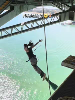 The cover image shows a young woman in free fall, the camera follows above her, from the top of a bridge, she is wearing a black tank top and gray pants, a harness is strapped to her waist. Arms are outstretched and her hair is flowing. Behind is a large bridge and the horizon.