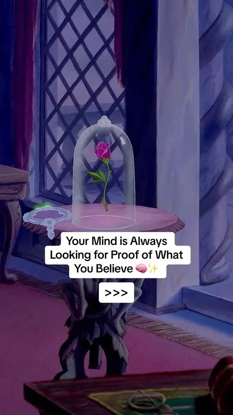 The image is a still from a Disney movie, likely 'Beauty and the Beast.' It shows a rose inside a glass dome on a table. Behind it is a window with a diamond-shaped pattern. The background has a dark purple/blue tone with architectural details and draped fabric.