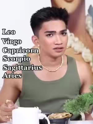 The cover image features a person with dark hair, wearing a green tank top and a delicate necklace. Text overlays on the image list astrological signs. The person is in a natural setting, likely an interior, with a neutral backdrop.