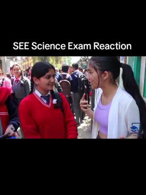 A video cover image shows two young women in a casual outdoor setting, likely after an exam. The image is mostly outdoors with other students in the background, creating a sense of a shared experience. One girl is wearing a red sweater, while the other is wearing a purple top and white jacket, The composition suggests a focus on social interaction and reactions, implying this is a candid, post-exam moment.