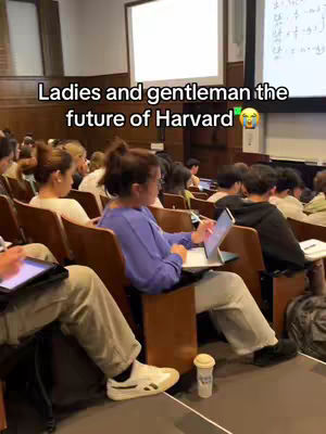 The image shows a lecture hall setting at Harvard University. Several students are seated in wooden chairs, some with open laptops. The text overlay reads, 'Ladies and gentlemen the future of Harvard'