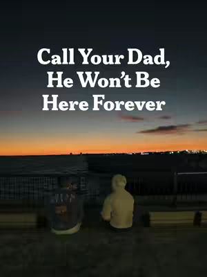 An image of a serene evening scene with a dark sky and an orange and yellow sunset over the ocean. In the foreground, on a dark surface, are two figures from the back. Text overlayed reads, 'Call Your Dad, He Won't Be Here Forever.'