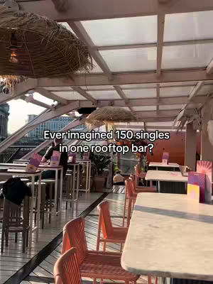 Interior shot of a rooftop bar with a retractable roof. Tables and chairs are set up, and there is text overlayed on the image. A figure is standing near a table.