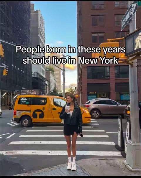 A woman stands on a crosswalk in New York City, holding a coffee cup. A yellow taxi and other cars drive by in the background, with tall buildings visible in the surroundings. Text overlay indicates the video's theme. The composition is a mix of urban life and personal style.